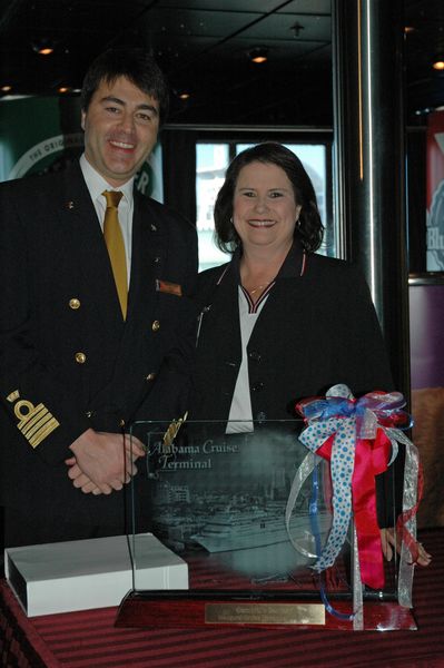 Carnival Fantasy Captain Roberto Costi (left) is presented with an etched, illuminated plaque of the Carnival Fantasy from the Port of Mobile’s Operations Manager Sheila Gurganus. 