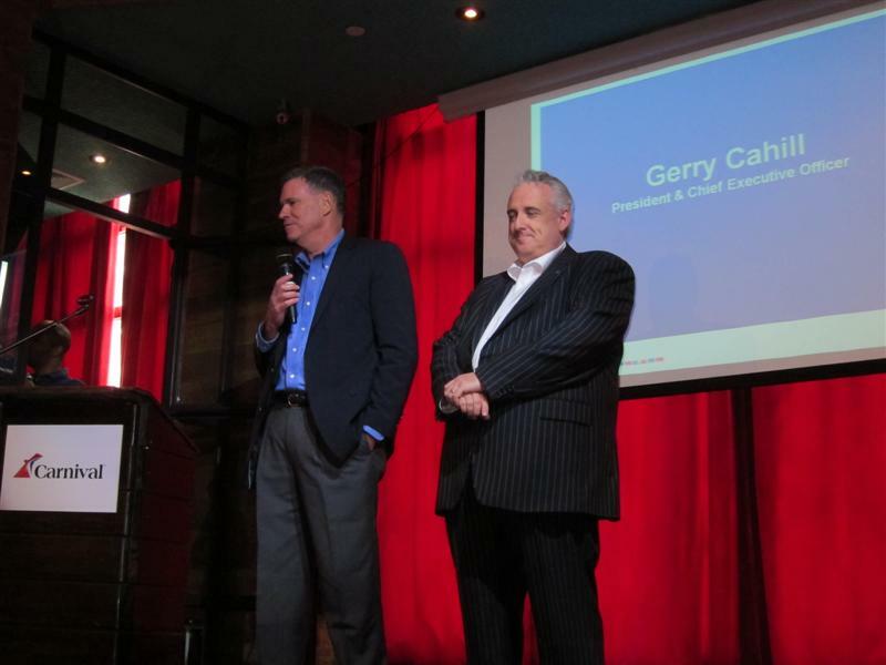 Gerry Cahill, president and CEO of Carnival Cruise Lines (left), and John Heald, senior cruise director (right), at the announcement in New York