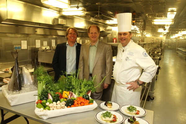 Executive Chef, Udo Sandering (right), ms  Westerdam, shows Dan Grausz (center), executive vice president, fleet operations, Holland America Line, and Dr. Lance Morgan (left), president and chief executive officer, Marine Conservation Institute, the sustainable seafood lunch he prepared.  The day’s menu included Grilled Scallops in Ginger Soy Glaze and Olive Oil Poached Pacific Black Cod, all purchased sustainably. 