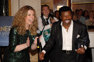 Cruise Director Lisa Ball presents singer Tony Tillman with the award for 2012 Entertainer of the Year.