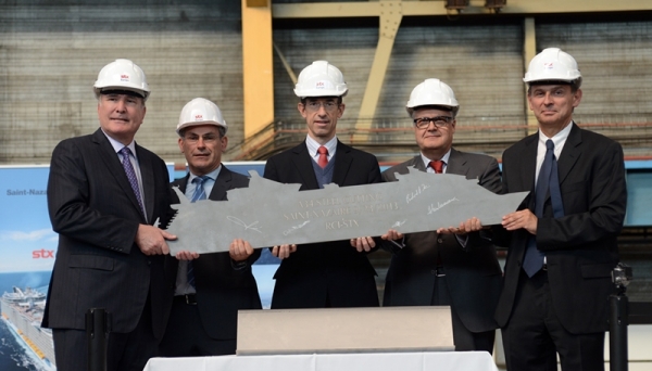 Royal Caribbean International cut the first piece of steel today for its third Oasis-class ship, marking the first construction milestone for a vessel that, at approximately 227,700 GRT, will be the world’s largest and most innovative cruise ship. Royal Caribbean Cruises, Ltd.’s Chairman and Chief Executive Officer, Richard D. Fain, Yves Joaven, operations director, STX France, Royal Caribbean International President and CEO, Adam Goldstein, Executive Vice President Newbuild and Fleet Design, Harri Kulovaara and Laurent Castaing, chief executive officer, STX France attended the event at the STX shipyard in Saint-Nazaire, France, where the ship will be built. The cruise line’s third Oasis-class ship is expected to be delivered in mid-2016.