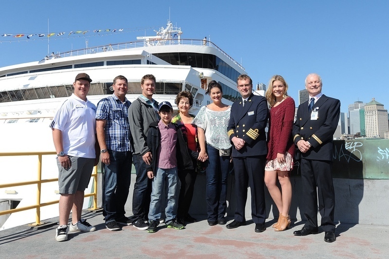 The 100,000th Maasdam passenger to disembark in Montréal, Ms. Marianne Visser from California, surrounded by her family, the ship’s captain, Mr. Ane Jan Smit and Port of Montréal representatives. (CNW Group/Tourisme Montréal)