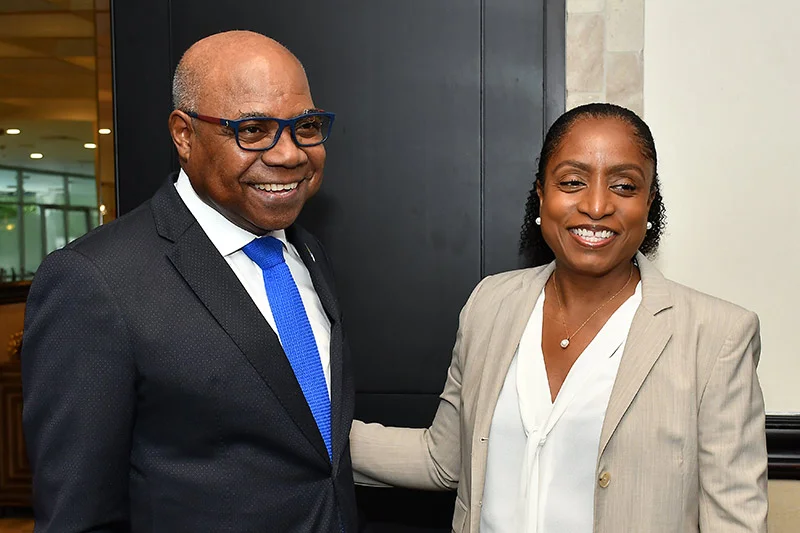 Edmund Bartlett (left), warmly greets Marie McKenzie