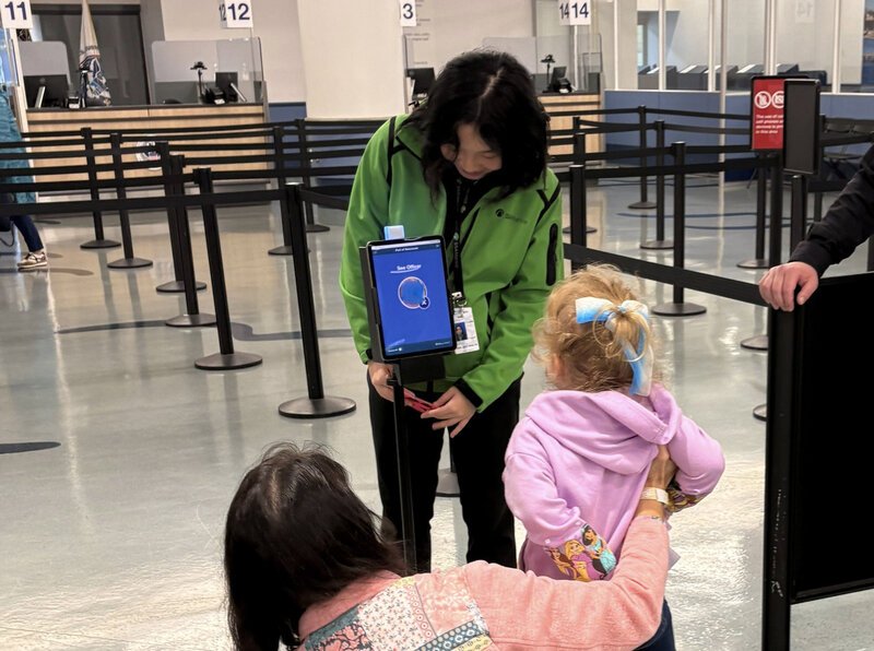 Lowering the tablet for the younger passengers.